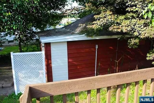 a backyard of a house with wooden floor barbeque oven and yard
