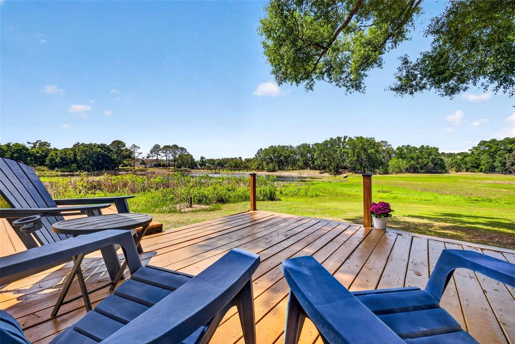 16330 Hanna Road Lutz, FL 33549 - Photo 32 of 41 a view of a patio with wooden floor and outdoor seating