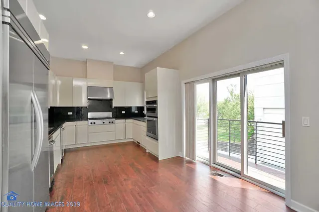 a kitchen with white cabinets and appliances