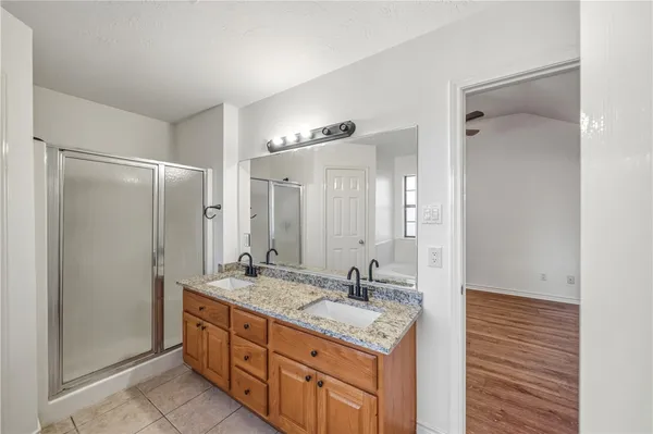 a bathroom with a granite countertop sink shower double and a mirror