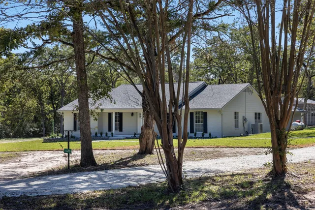 a view of a house with swimming pool and yard