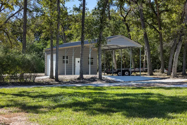 a view of a house with backyard and sitting area
