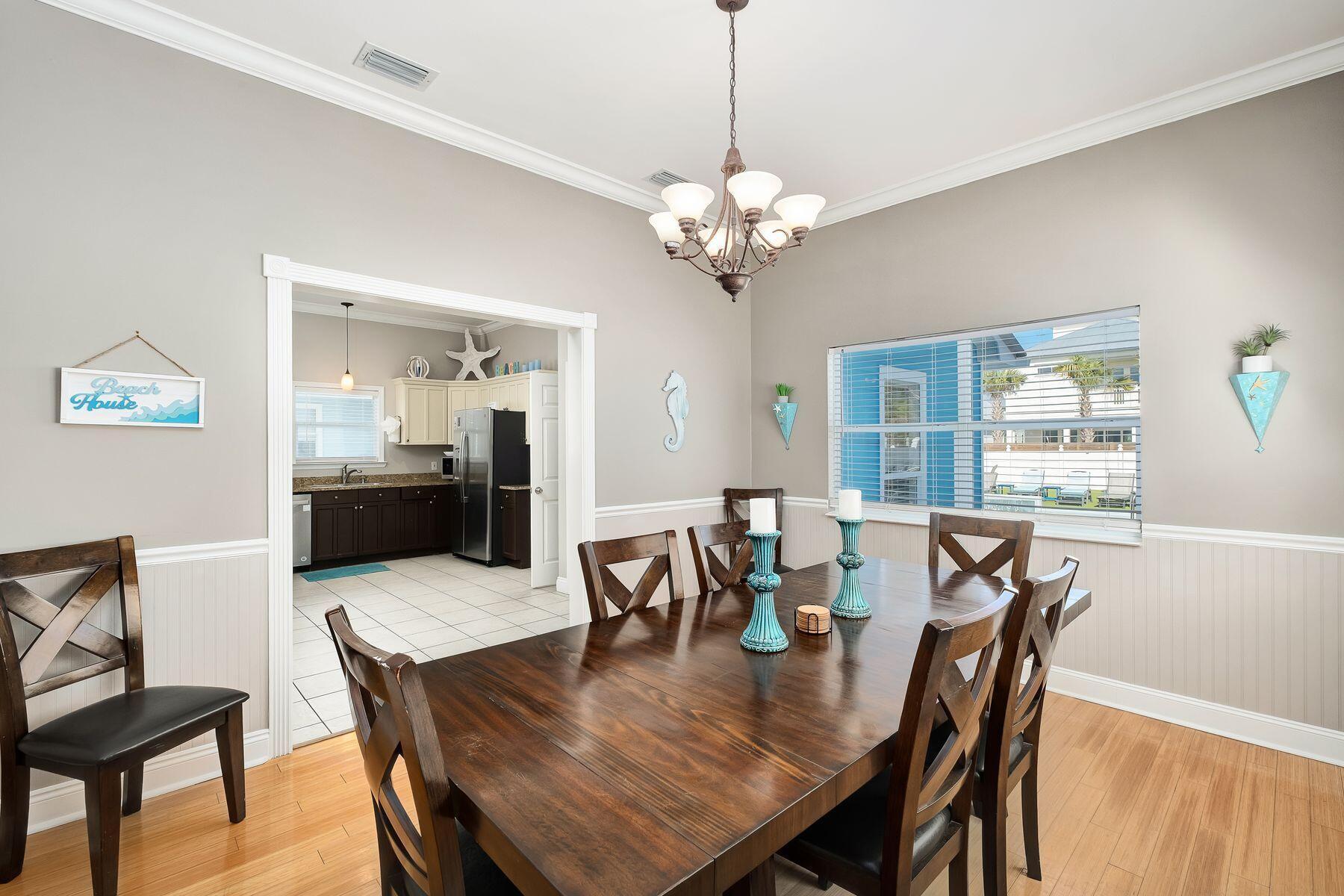 172 Sugar Sand Lane Santa Rosa Beach, FL 32459 - Photo 11 of 40 a view of a dining room with furniture window and wooden floor