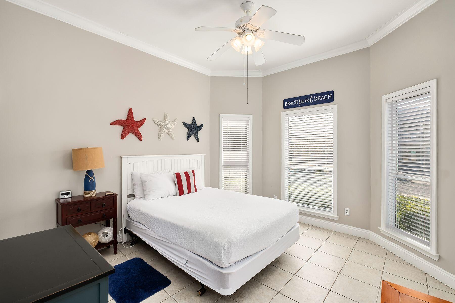 172 Sugar Sand Lane Santa Rosa Beach, FL 32459 - Photo 13 of 40 a bedroom with a bed and a chandelier