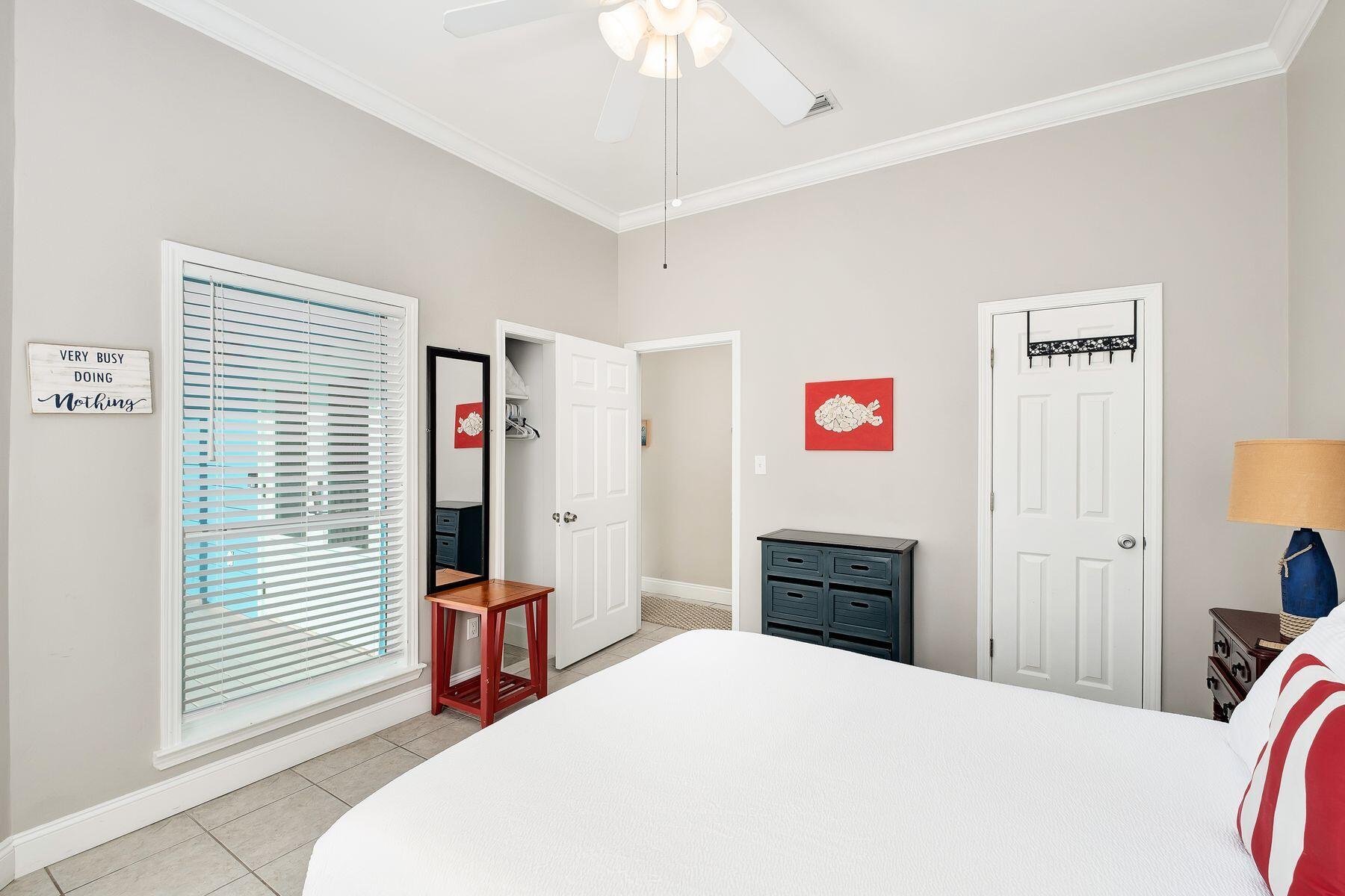 172 Sugar Sand Lane Santa Rosa Beach, FL 32459 - Photo 14 of 40 a bedroom with a bed and a chandelier