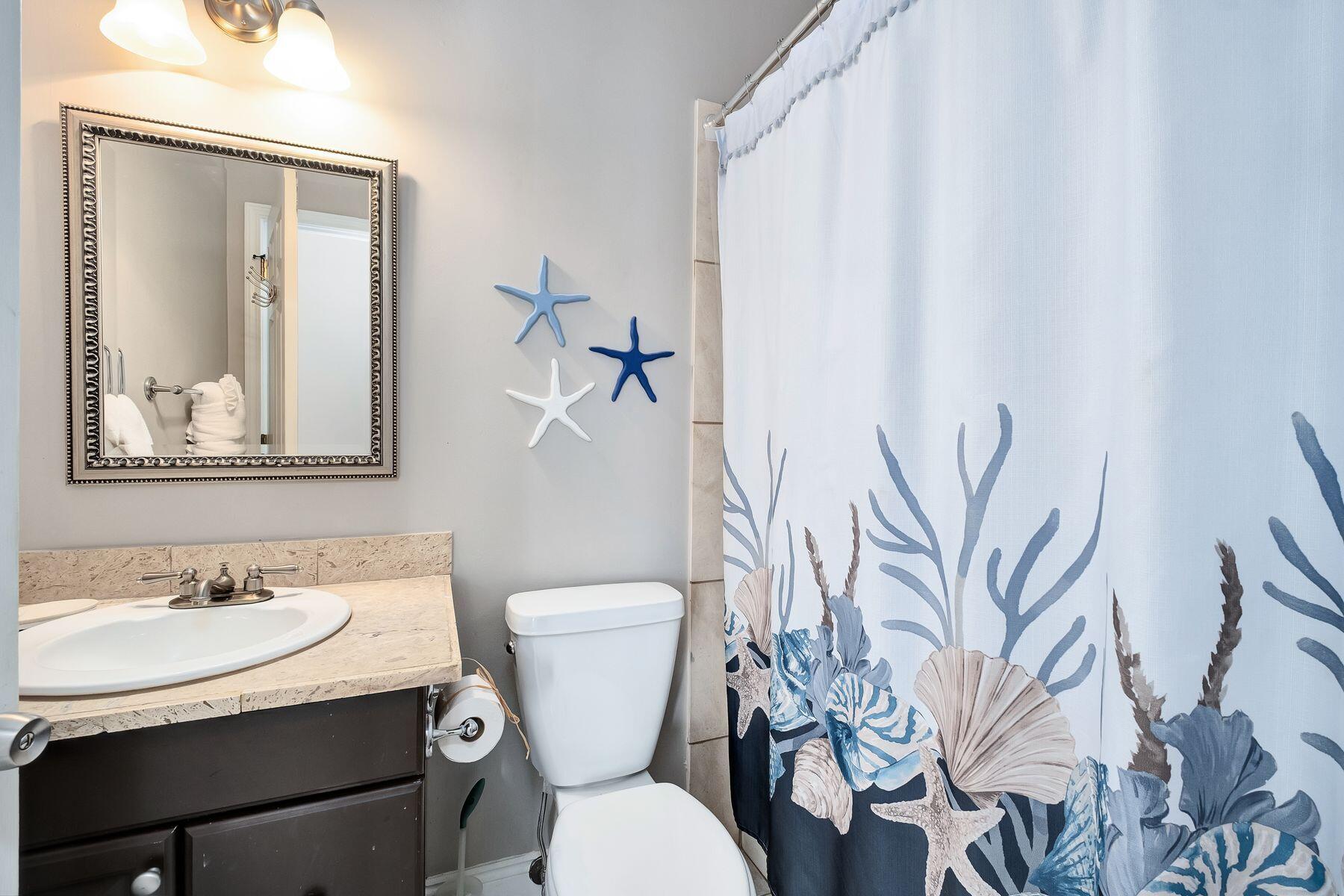172 Sugar Sand Lane Santa Rosa Beach, FL 32459 - Photo 15 of 40 a bathroom with a toilet sink and mirror