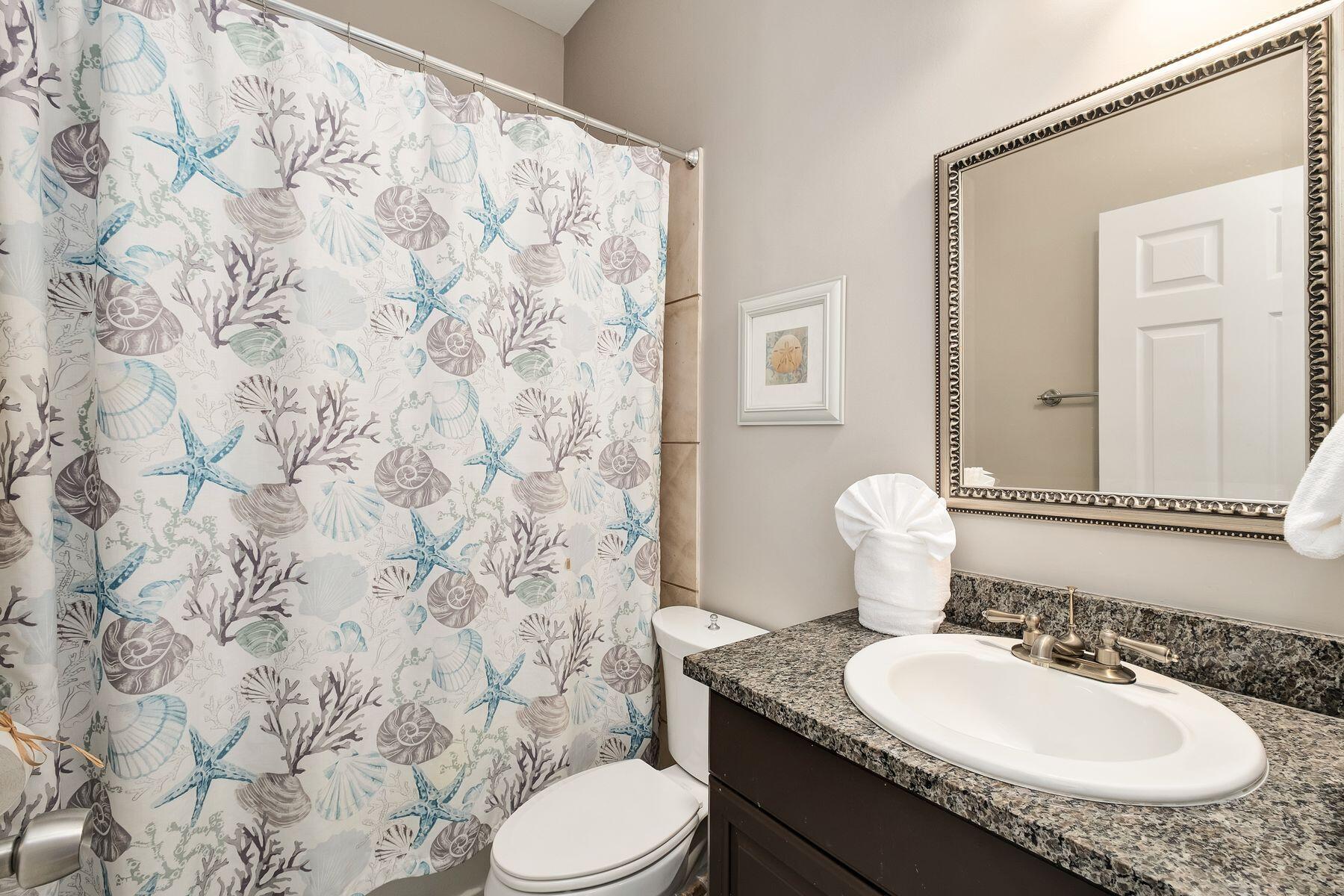 172 Sugar Sand Lane Santa Rosa Beach, FL 32459 - Photo 20 of 40 a bathroom with a granite countertop sink and a mirror