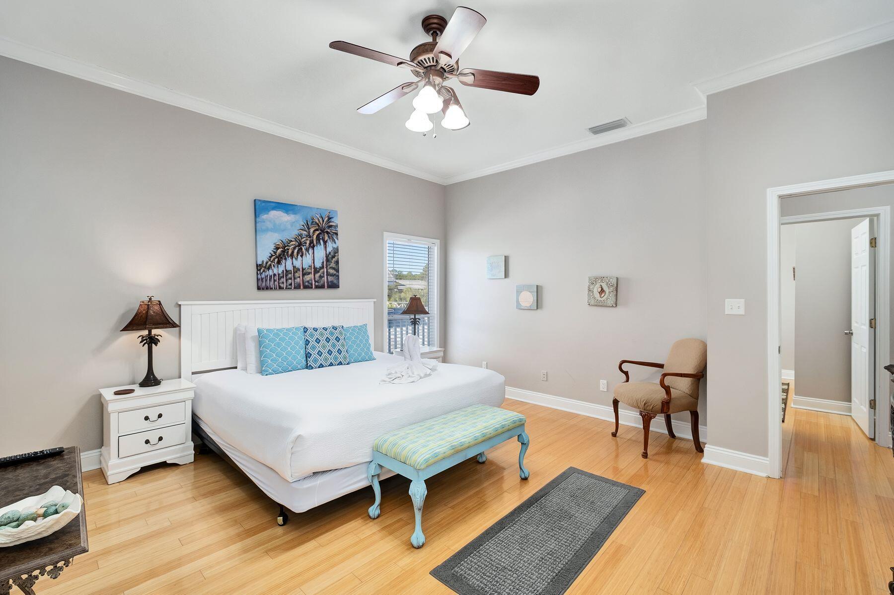 172 Sugar Sand Lane Santa Rosa Beach, FL 32459 - Photo 23 of 40 a bedroom with a bed and a chandelier