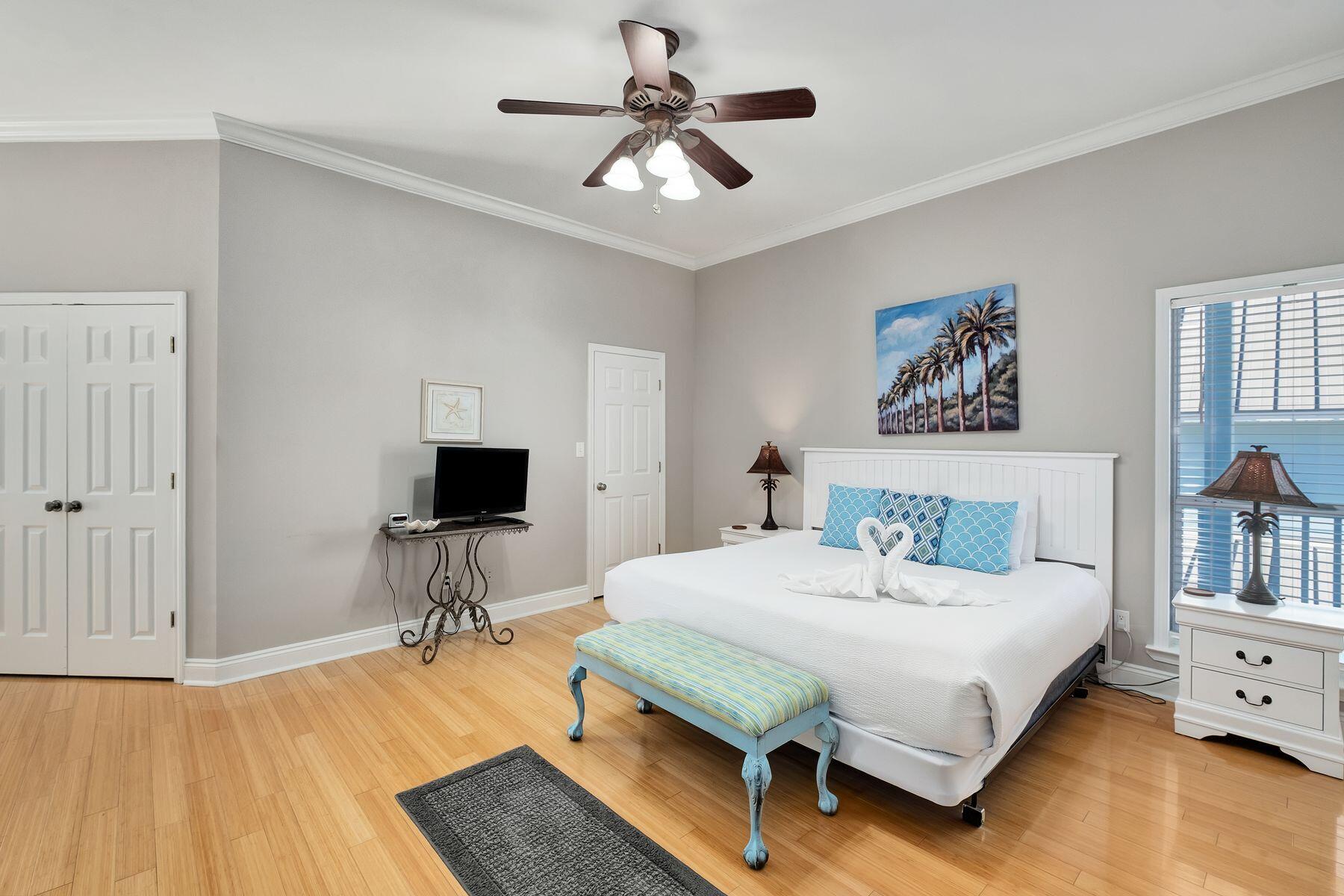 172 Sugar Sand Lane Santa Rosa Beach, FL 32459 - Photo 24 of 40 a bedroom with a bed and a chandelier