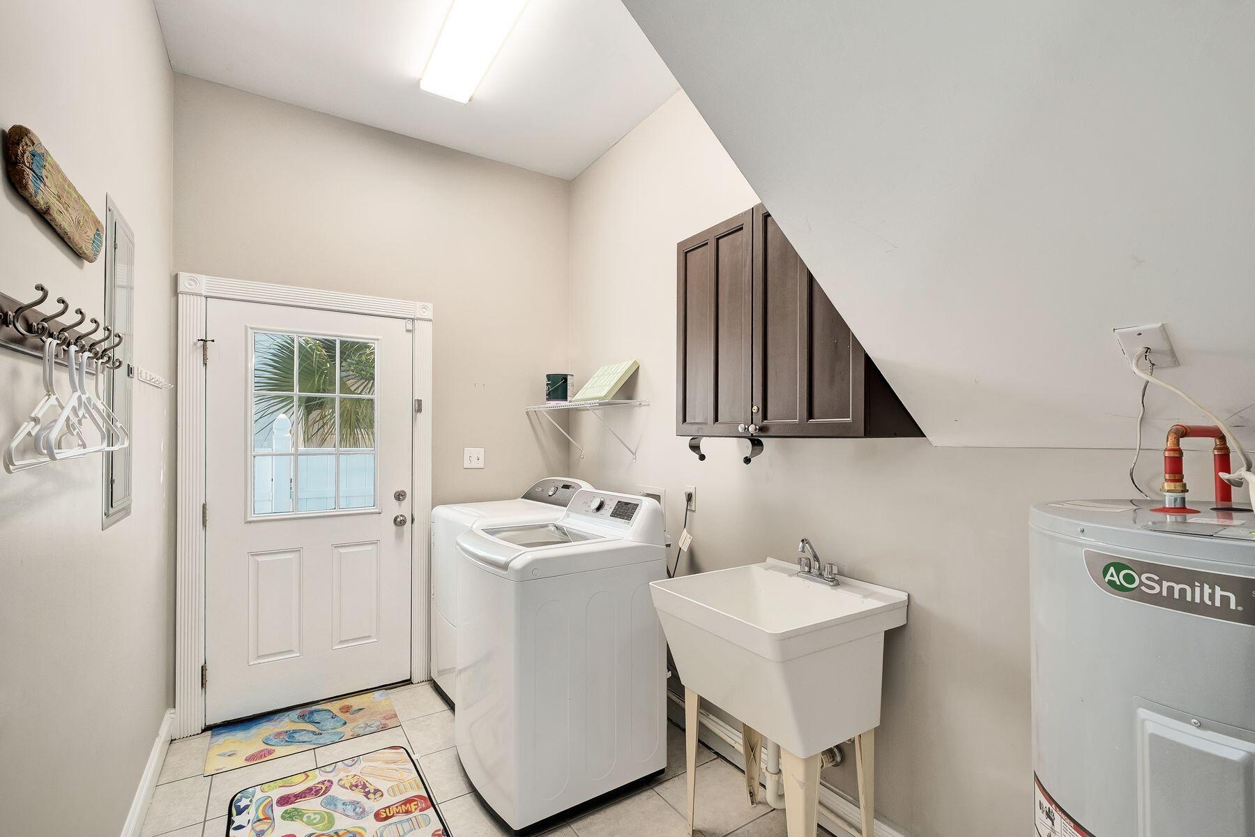172 Sugar Sand Lane Santa Rosa Beach, FL 32459 - Photo 33 of 40 a utility room with sink dryer and washer