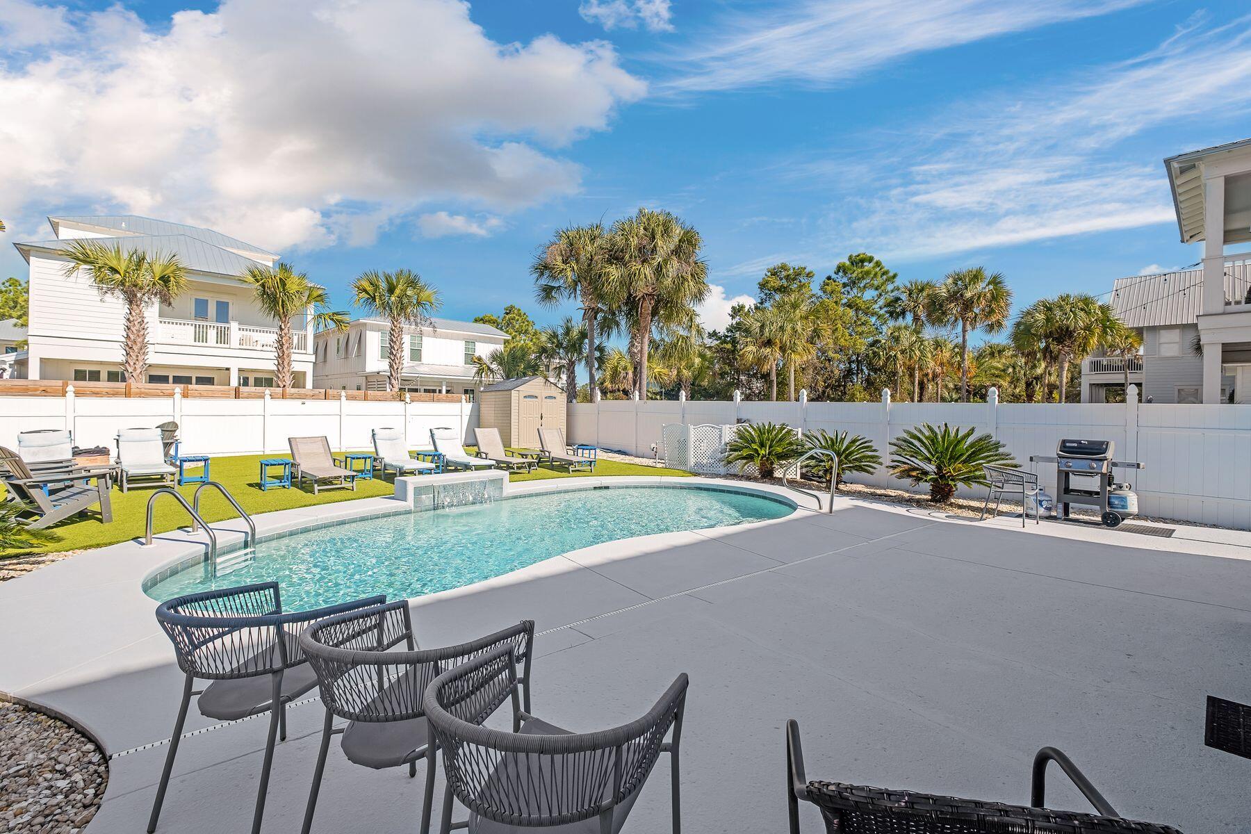 172 Sugar Sand Lane Santa Rosa Beach, FL 32459 - Photo 36 of 40 a view of a swimming pool with a lawn chairs