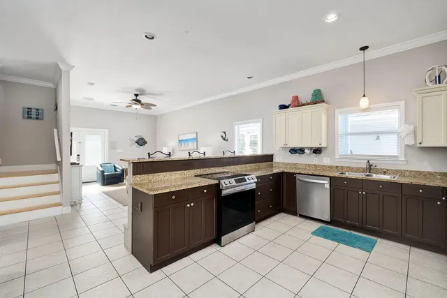 a kitchen with stainless steel appliances granite countertop a sink and cabinets