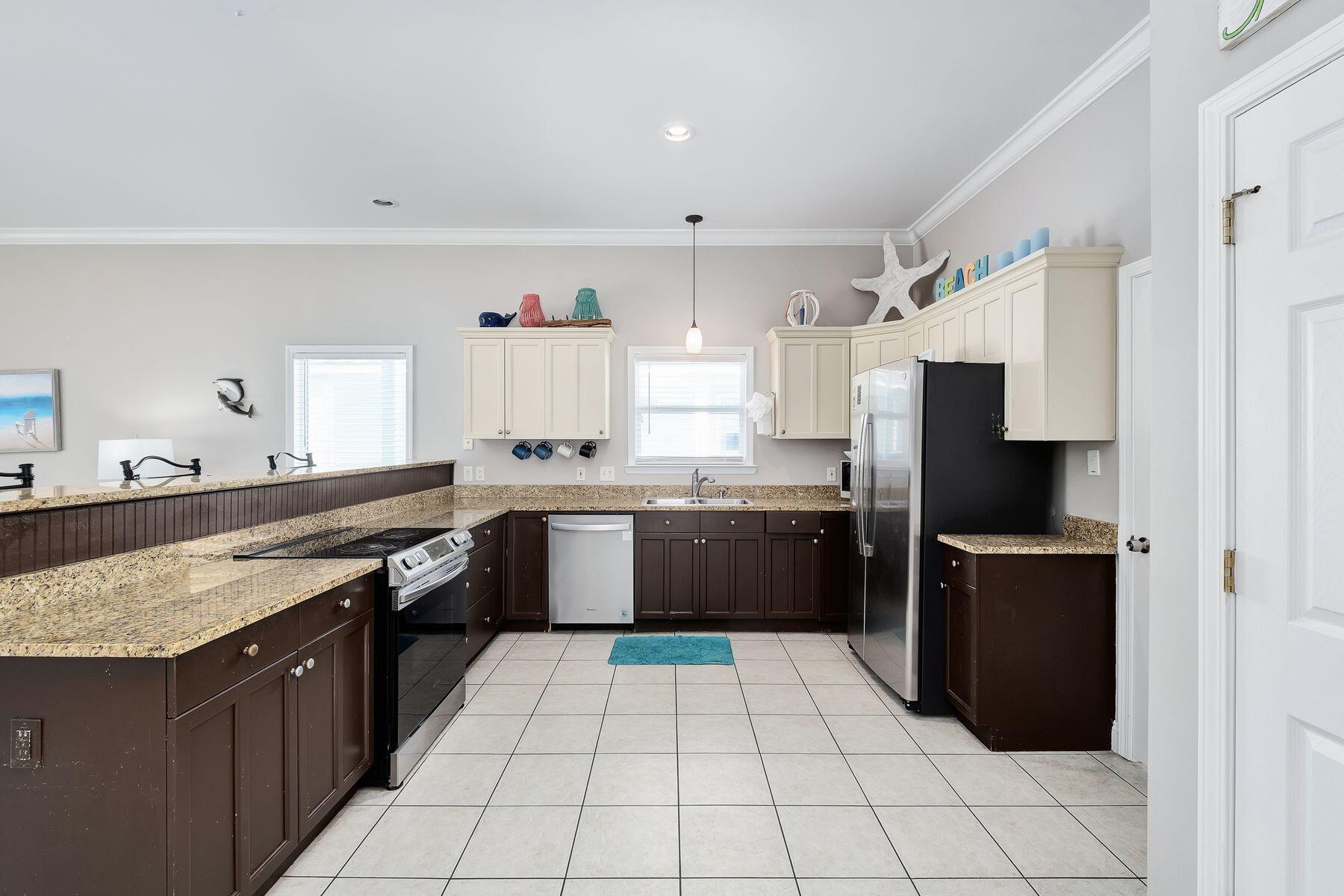 172 Sugar Sand Lane Santa Rosa Beach, FL 32459 - Photo 9 of 40 a large kitchen with a stove a refrigerator and a sink