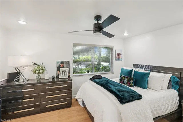 a bedroom with a bed and large window