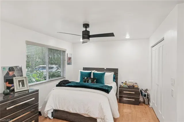 a bedroom with a bed and a large window