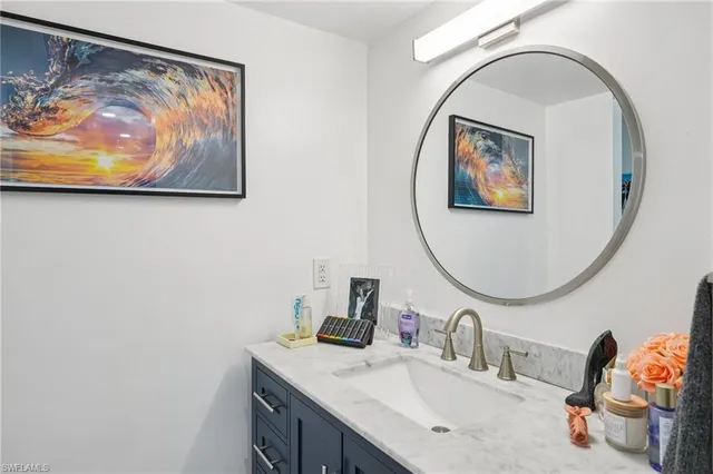 a bathroom with a sink mirror and vanity
