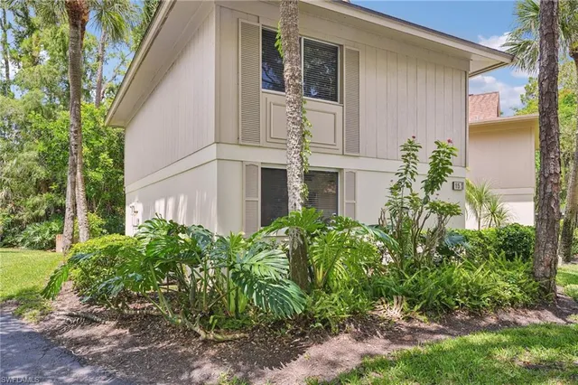 front view of a house with potted plants