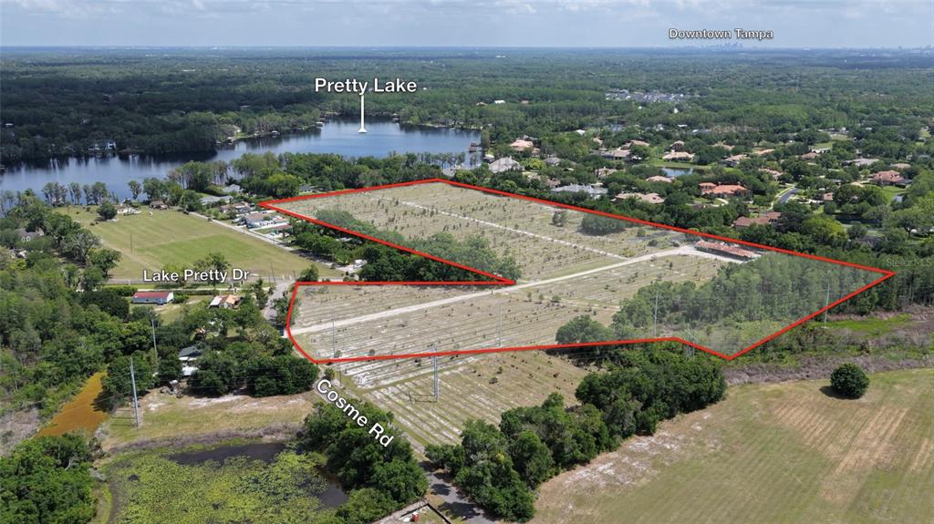 an aerial view of residential houses with outdoor space and river