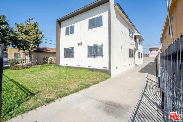 a view of white house with a yard