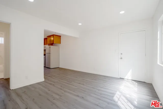 an empty room with wooden floor and closet