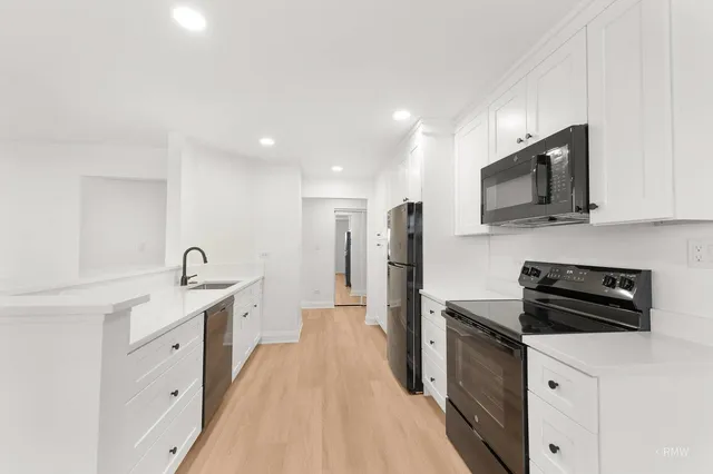a kitchen with stainless steel appliances a sink stove and refrigerator