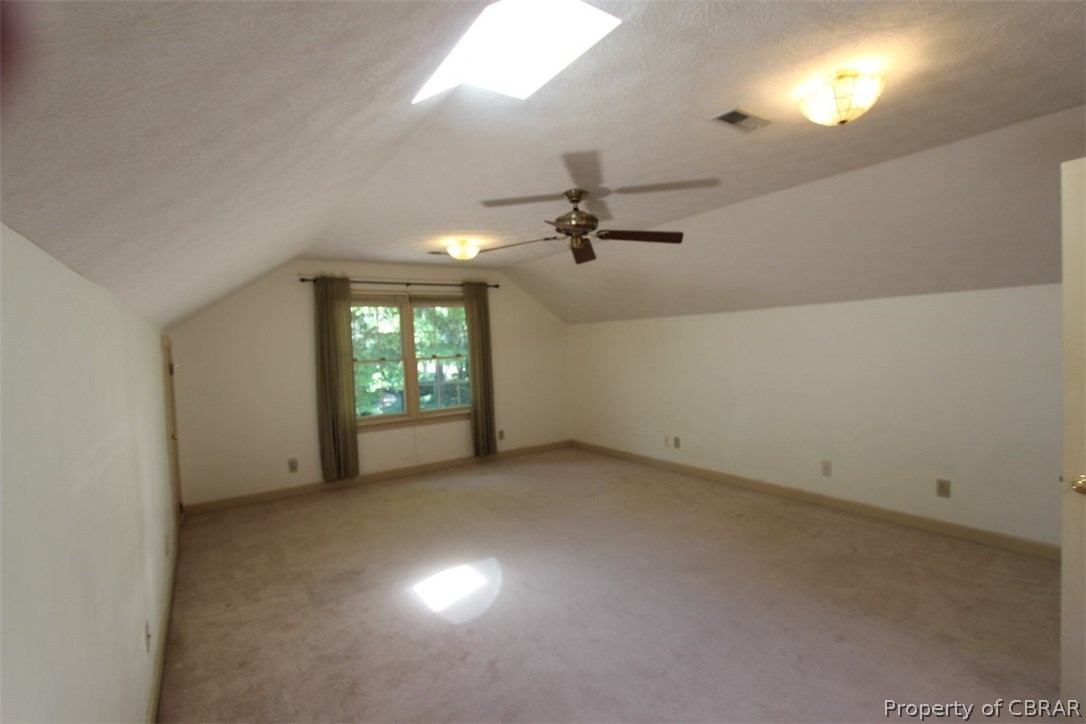 308 Tides Run Yorktown, VA 23692 - Photo 19 of 34 an empty room with chandelier fan and windows