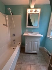 38 Cedar Street, Unit 1 Holliston, MA 01746 - Photo 13 of 15 a bathroom with a sink a toilet and bathtub