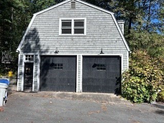 38 Cedar Street, Unit 1 Holliston, MA 01746 - Photo 15 of 15 a front view of a house with a garage
