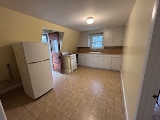 38 Cedar Street, Unit 1 Holliston, MA 01746 - Photo 4 of 15 a kitchen with a refrigerator and a sink