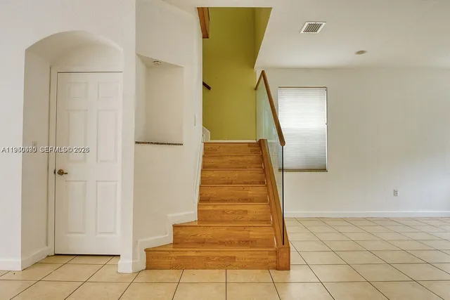 a view of a hallway with wooden floor and entryway