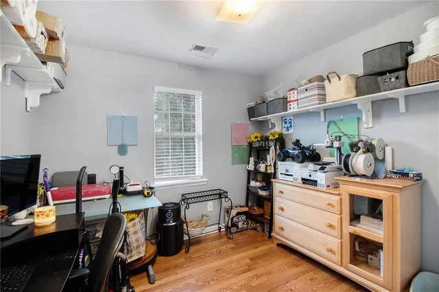 a view of a workspace with furniture and a window