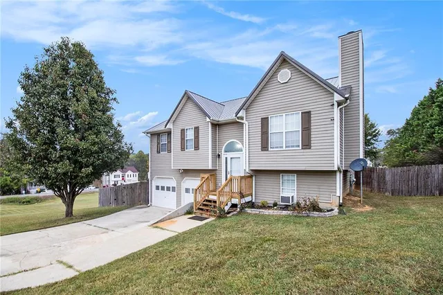 a view of house with backyard