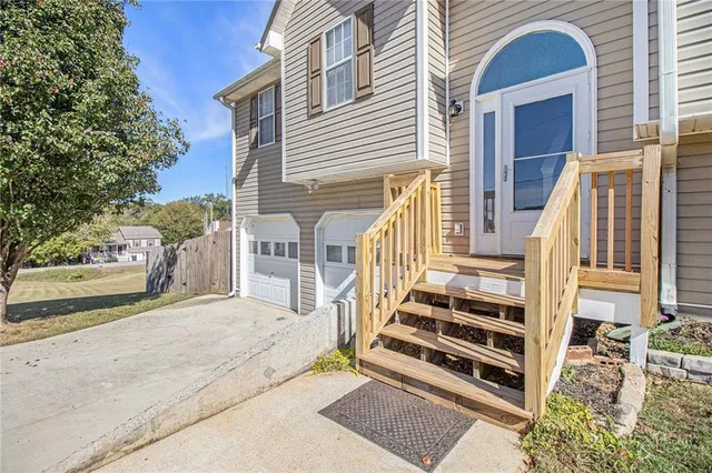 a view of front door of house with stairs
