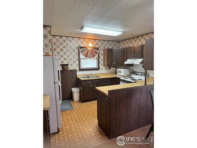 a kitchen with a sink cabinets and a window