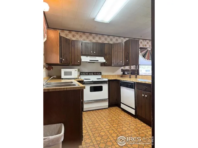 a kitchen with a sink cabinets and appliances