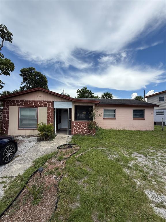 9061 Sunrise Drive Largo, FL 33773 - Photo 1 of 1 a view of a house with a back yard