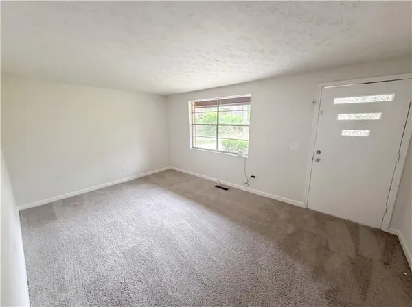 an empty room with a empty space and windows