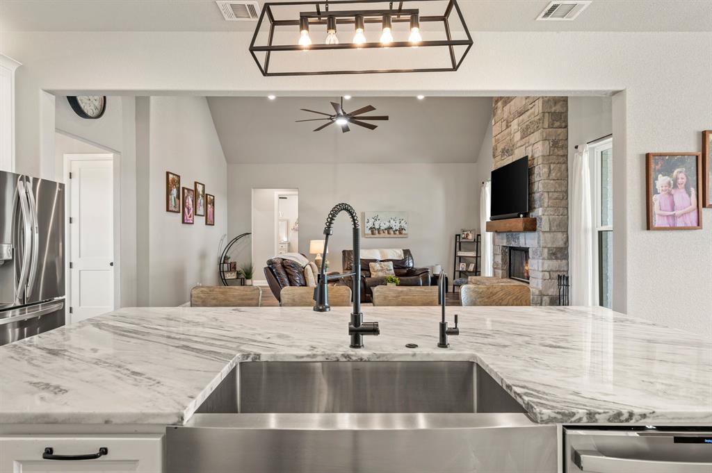 175 County Road 1109 Decatur, TX 76234 - Photo 14 of 39 a kitchen with a sink and a refrigerator