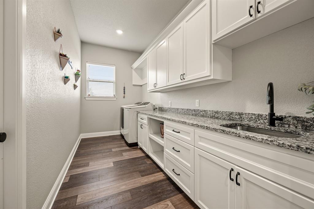 175 County Road 1109 Decatur, TX 76234 - Photo 17 of 39 a kitchen with granite countertop white cabinets and white appliances