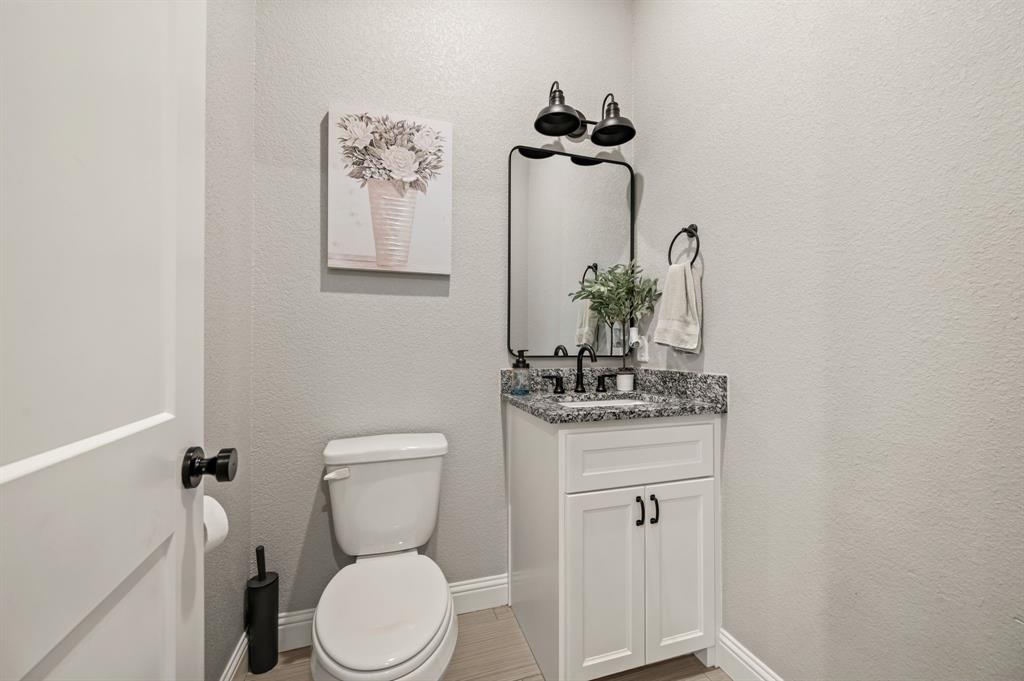 175 County Road 1109 Decatur, TX 76234 - Photo 18 of 39 a bathroom with a toilet a sink and mirror