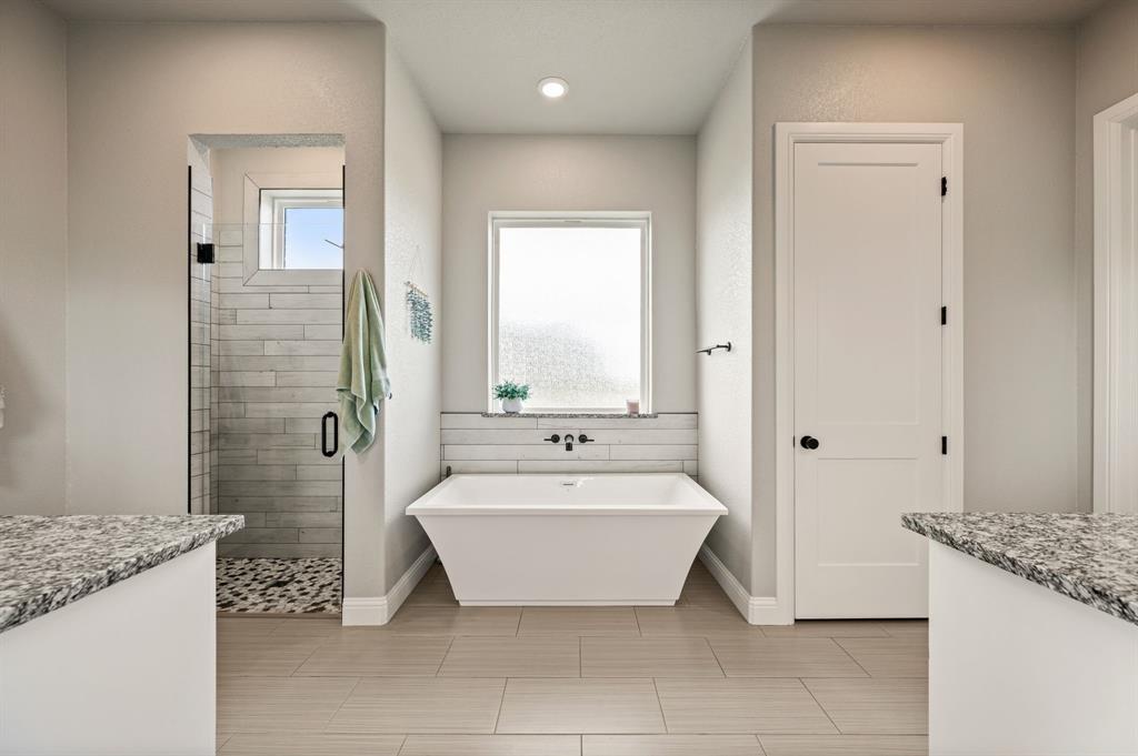 175 County Road 1109 Decatur, TX 76234 - Photo 20 of 39 a spacious bathroom with a granite countertop tub sink and mirror