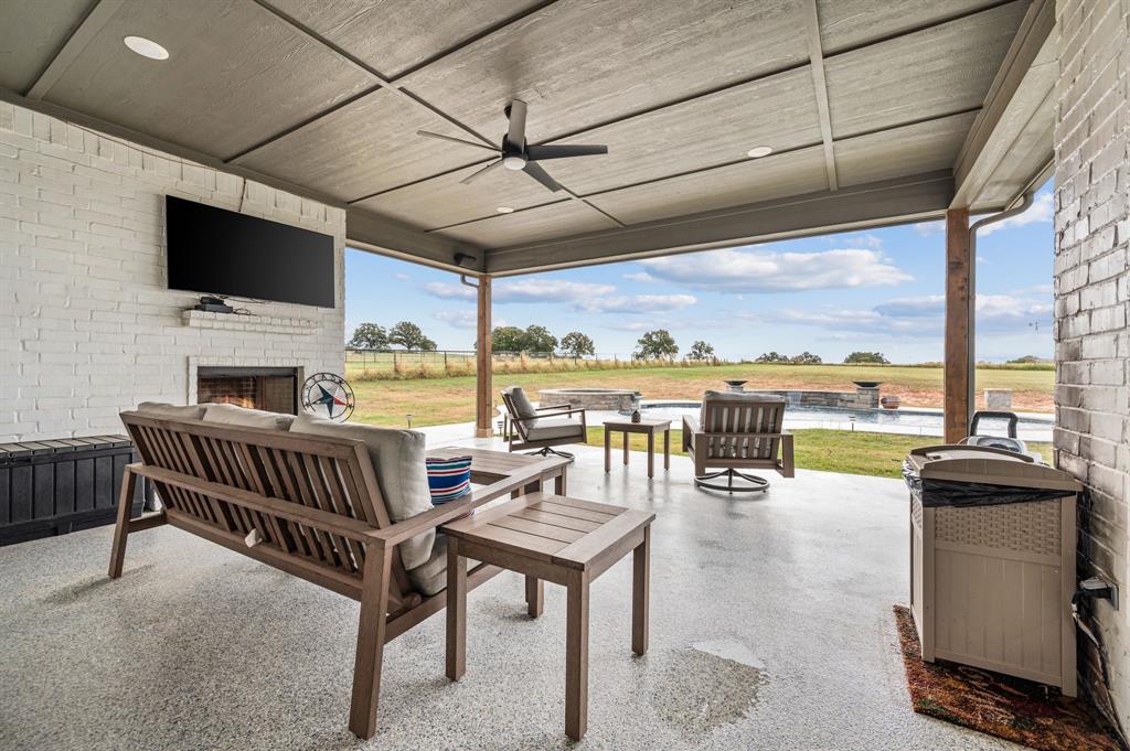 175 County Road 1109 Decatur, TX 76234 - Photo 26 of 39 a living room with patio furniture and a flat screen tv