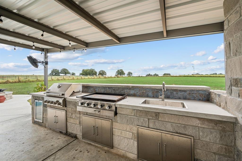 175 County Road 1109 Decatur, TX 76234 - Photo 31 of 39 a utility room with stainless steel appliances granite countertop a sink and a stove