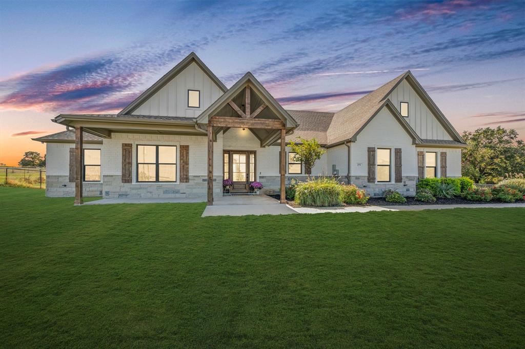175 County Road 1109 Decatur, TX 76234 - Photo 5 of 39 a front view of a house with a garden