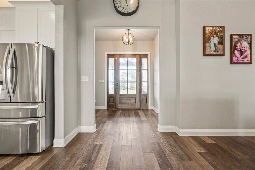 175 County Road 1109 Decatur, TX 76234 - Photo 7 of 39 a hallway with wooden floor and window