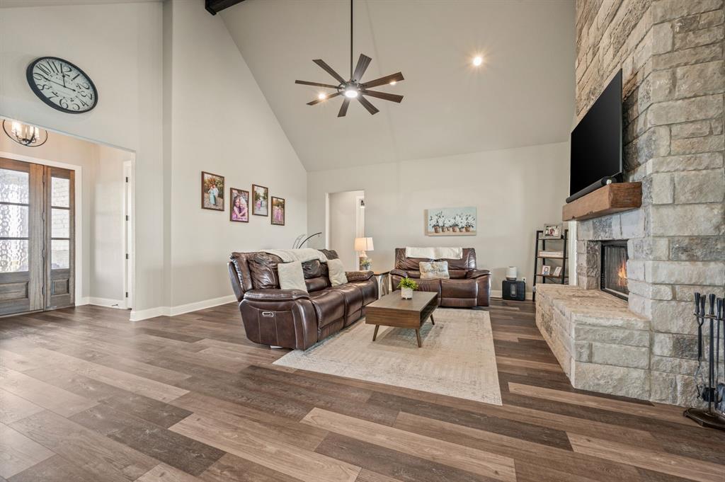 175 County Road 1109 Decatur, TX 76234 - Photo 8 of 39 a living room with fireplace furniture and a flat screen tv