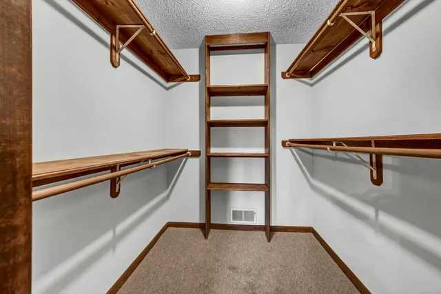 a bathroom with a sink a toilet a mirror and shower