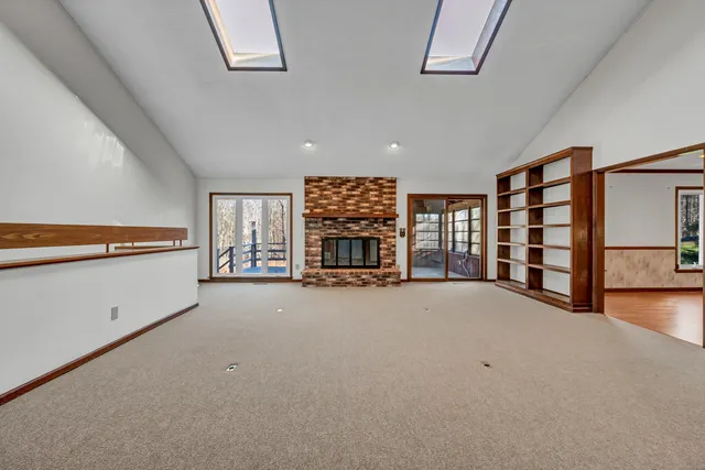 a view of empty room with windows and ceiling fan