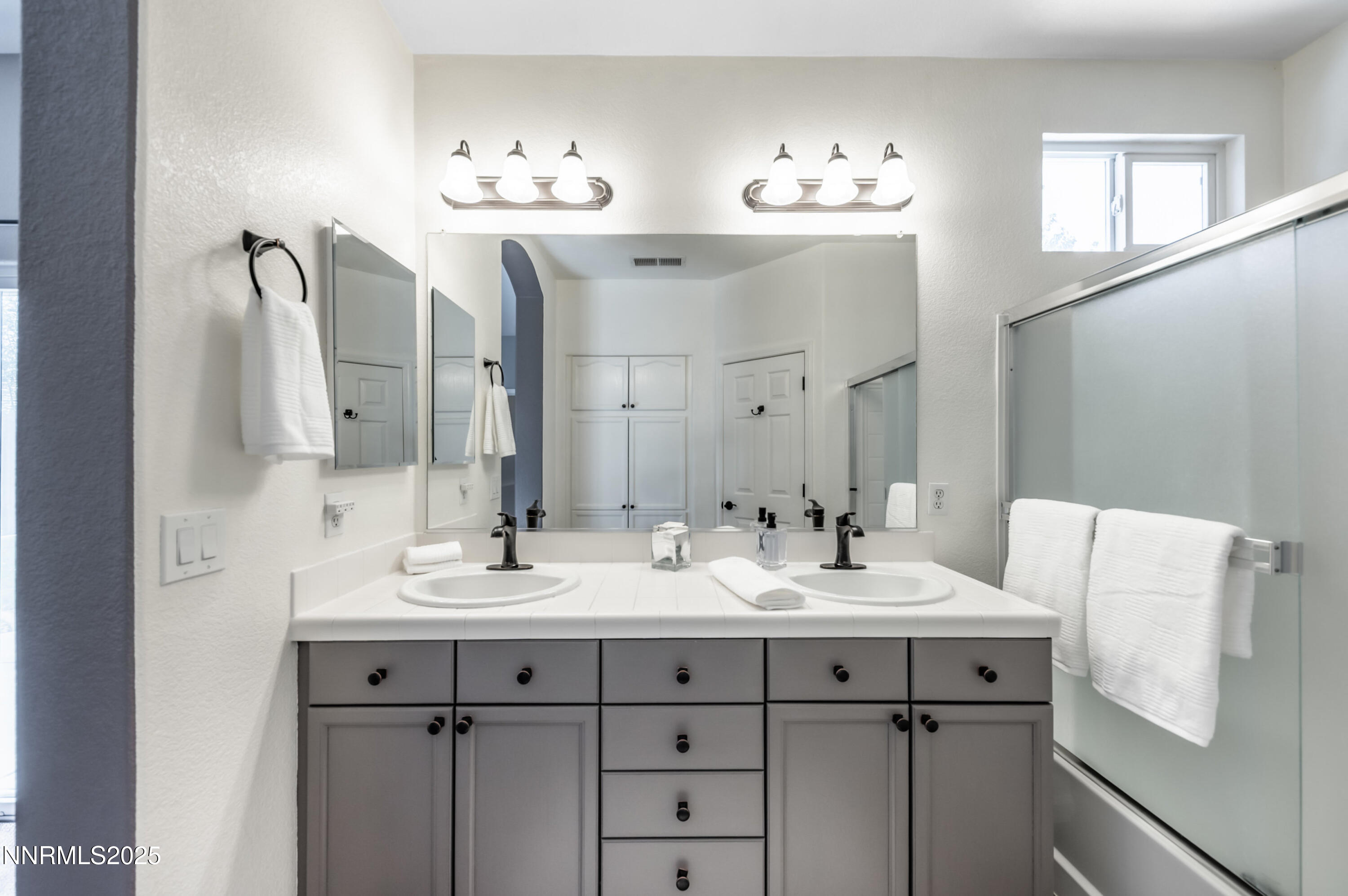 9578 Rusty Nail Court Reno, NV 89521 - Photo 20 of 38 a bathroom with a double vanity sink and a mirror