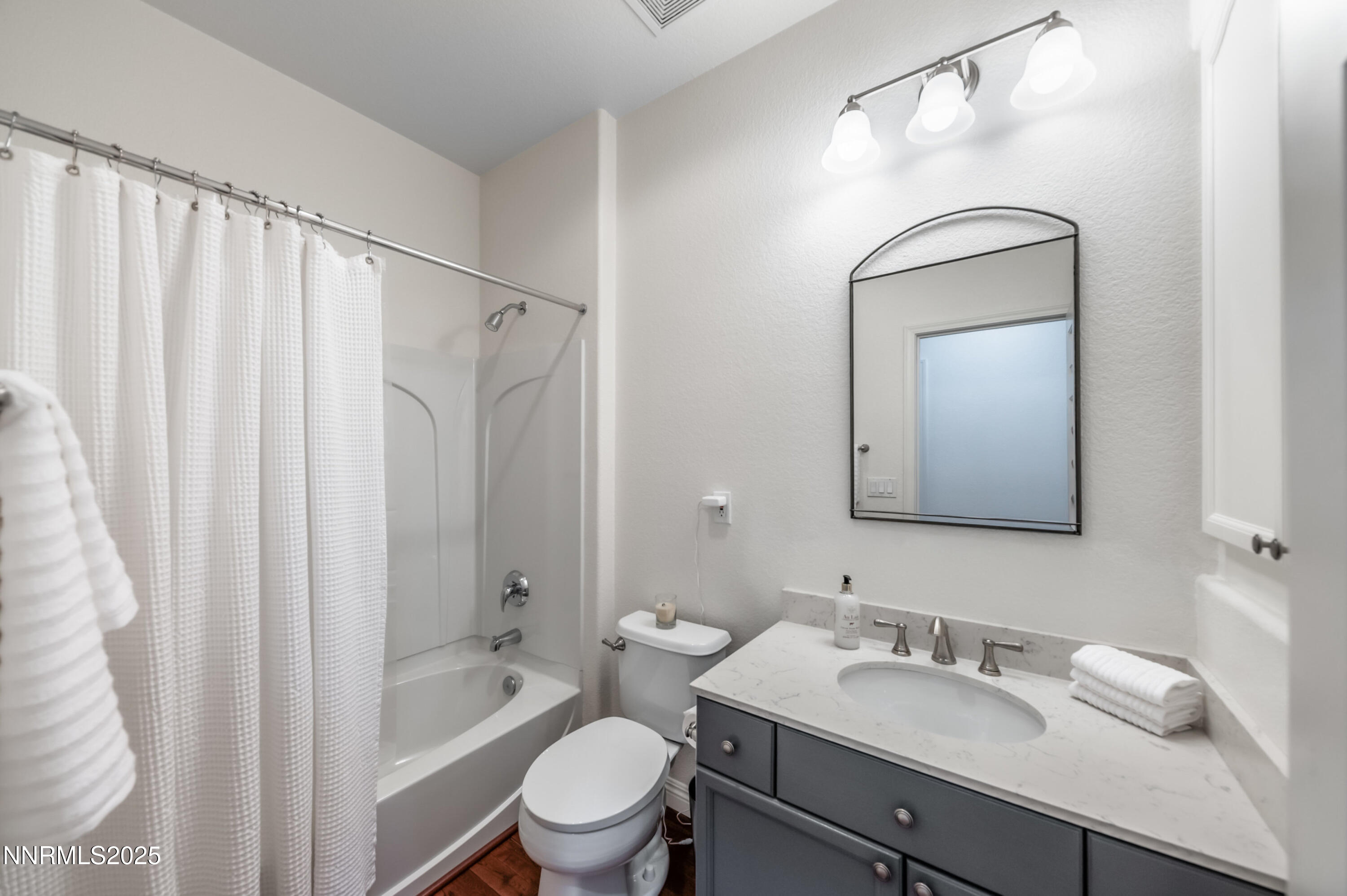 9578 Rusty Nail Court Reno, NV 89521 - Photo 23 of 38 a bathroom with a granite countertop sink toilet a mirror and shower
